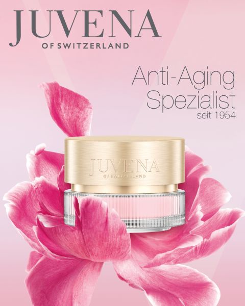 Davanti a un grande fiore rosa c'è un contenitore di crema anti-età di Juvena of Switzerland. Lo sfondo è una sfumatura di rosa e bianco. Il testo recita: "Juvena of Switzerland, specialista anti-età dal 1954".