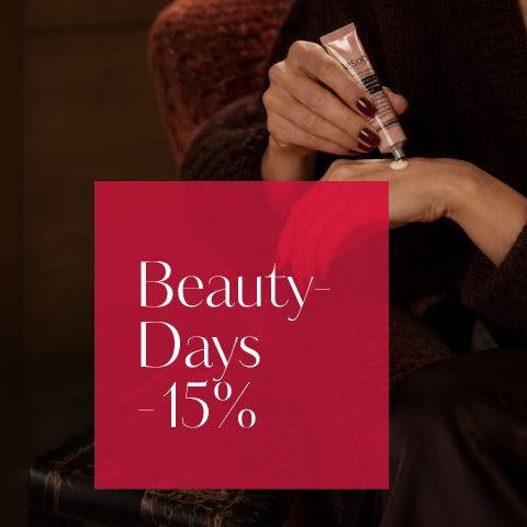 Una persona si spalma una crema sulla mano, accanto a lei c'è una scatola rossa con la scritta: "Beauty-Sale - 15%".