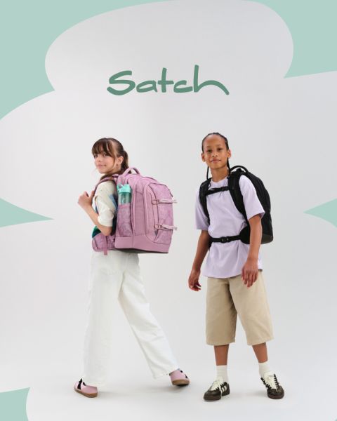 Quattro bambini con zaini posano in modo creativo in uno studio. Uno è in piedi su una scala e tiene un ciak, un altro parla in un megafono, altri due sono inginocchiati e seduti su cubi colorati. Si vede l'attrezzatura da studio.