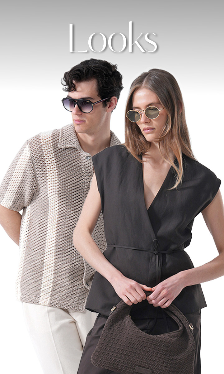 Un uomo con occhiali da sole e una camicia a fantasia sta dietro una donna con occhiali da sole e un outfit nero, che tiene in mano una borsa intrecciata, sopra c'è scritto "Looks".
